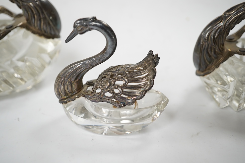 A graduated set of three silver mounted glass swan condiments, London, 1978, largest height 12.9cm. Condition - fair